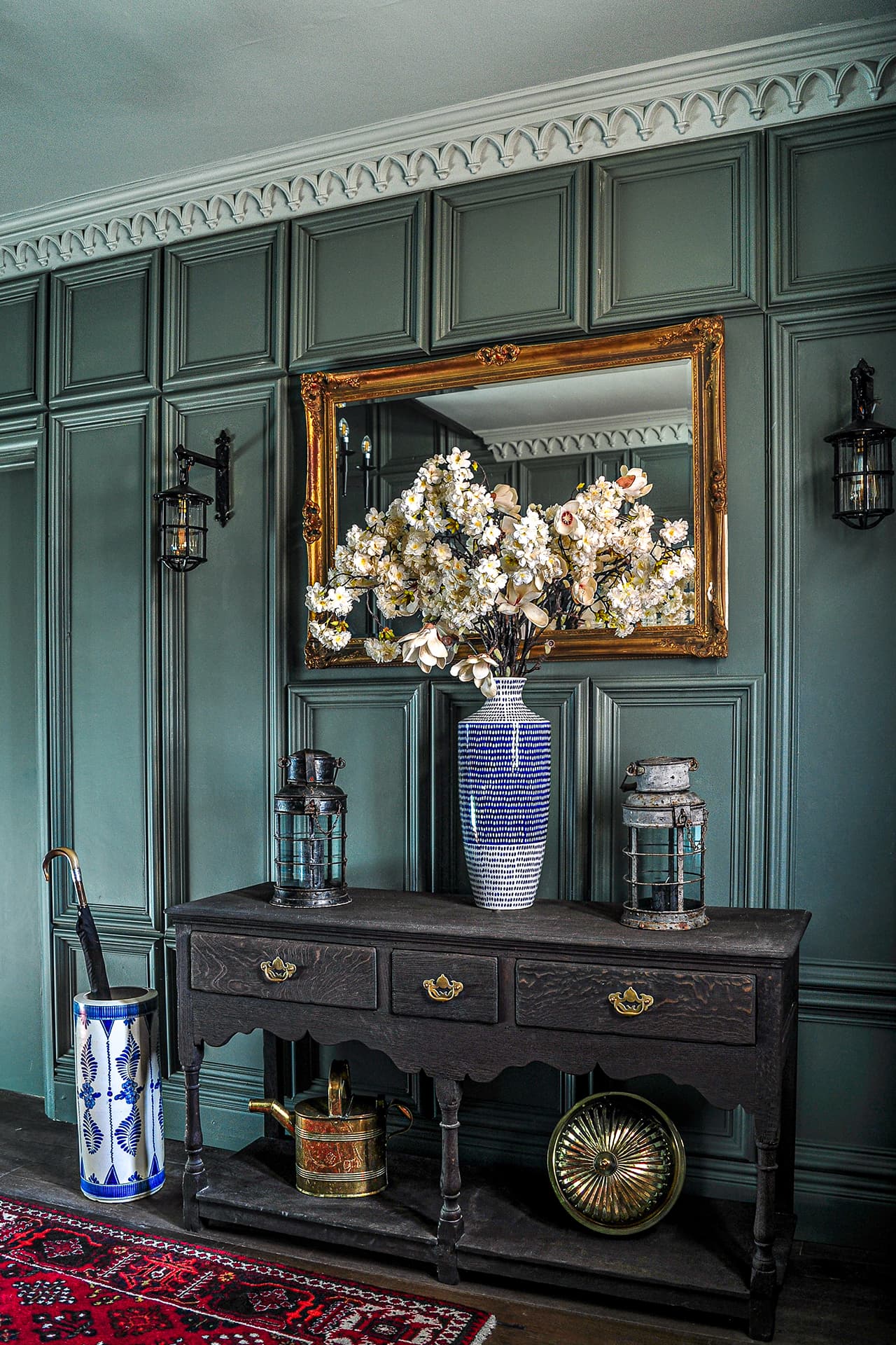 green panelled hallway with gothic style cornice