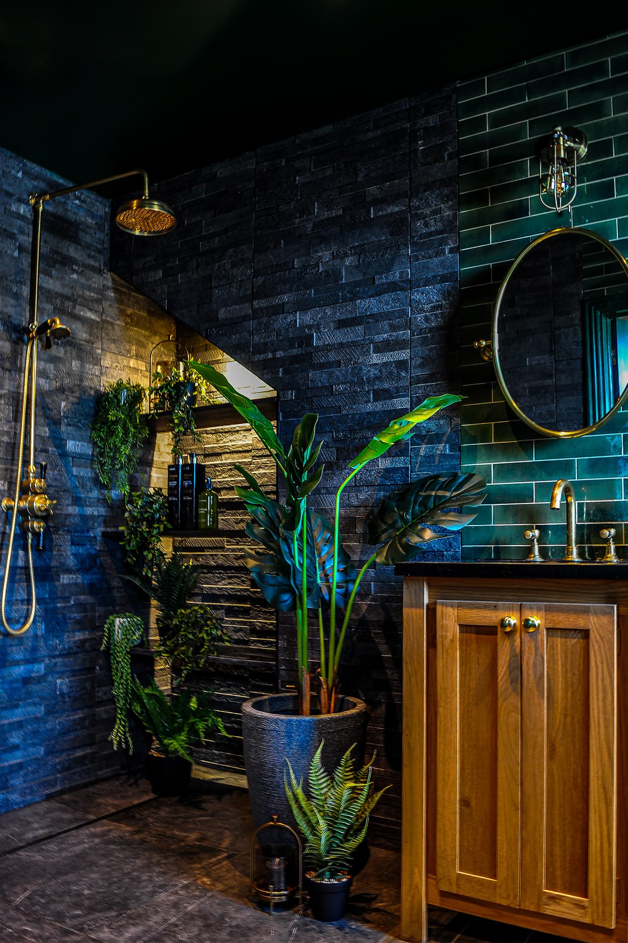 oak basin vanity with black marble top in a slate tiled ensuite bathroom