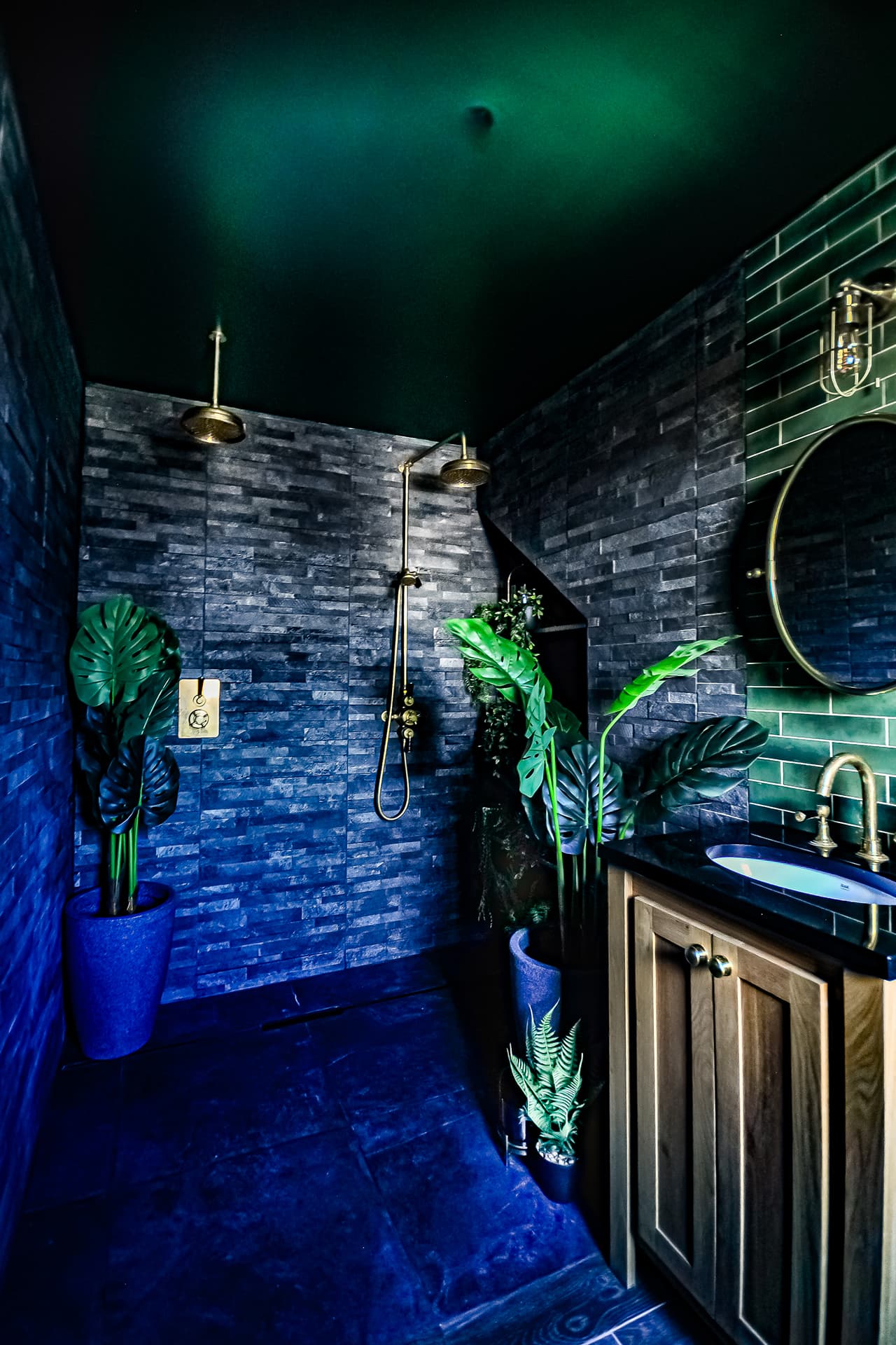 oak basin vanity with black marble top in a slate tiled ensuite bathroom