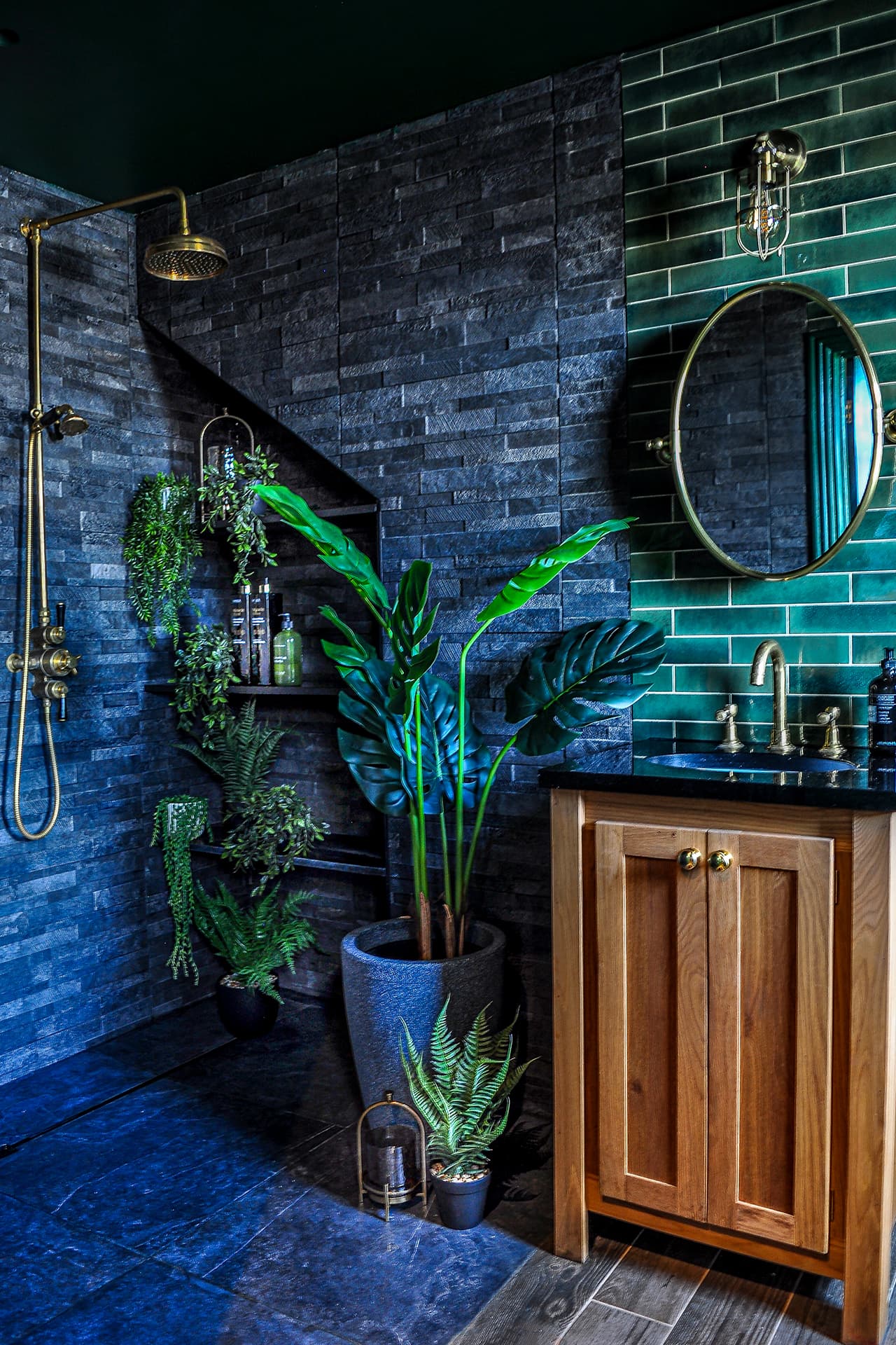 oak basin vanity with black marble top in a slate tiled ensuite bathroom