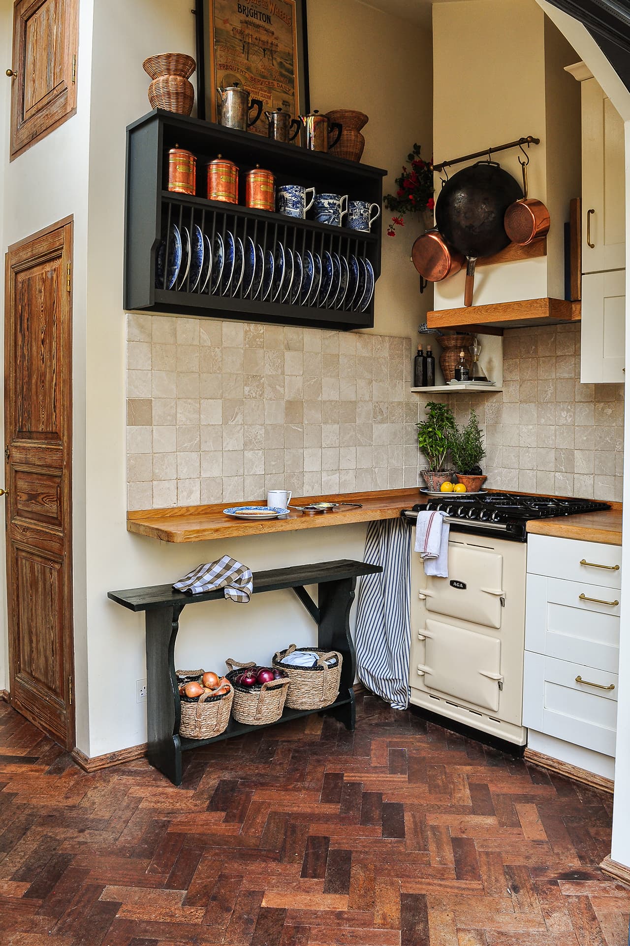 country style kitchen with dark green plate rack and cream aga oven