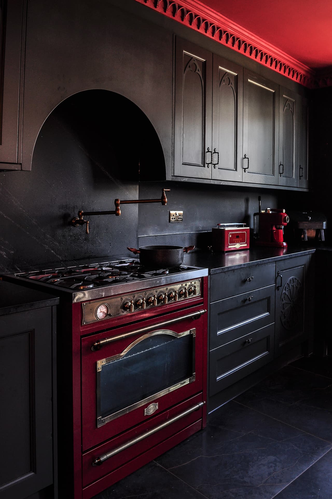 black gothic kitchen with red range cooker